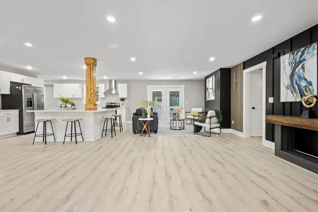 a view of a kitchen with kitchen island a large counter top furniture and a view of living room