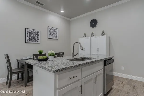 a bathroom with a granite countertop sink a mirror and vanity