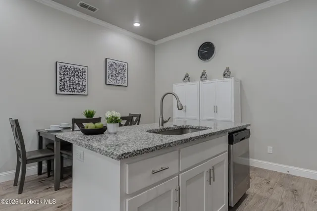 a bathroom with a granite countertop sink a mirror and vanity