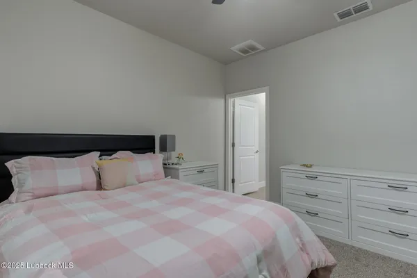 a bedroom with a bed and a night stand