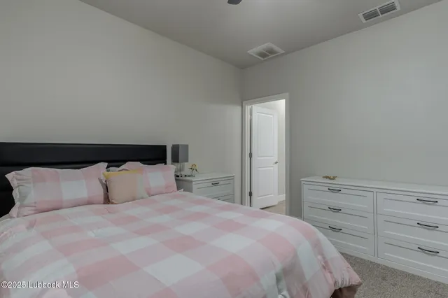 a bedroom with a bed and a night stand