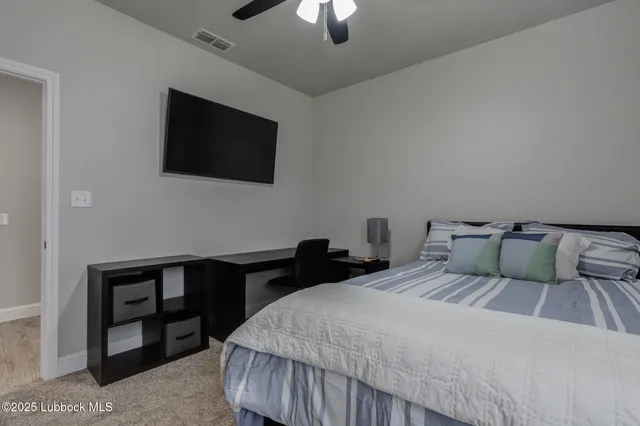 a bedroom with a bed and a flat screen tv
