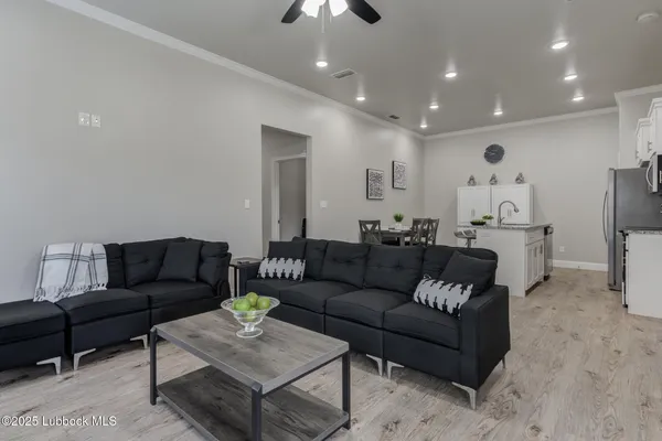 a living room with furniture and a chandelier
