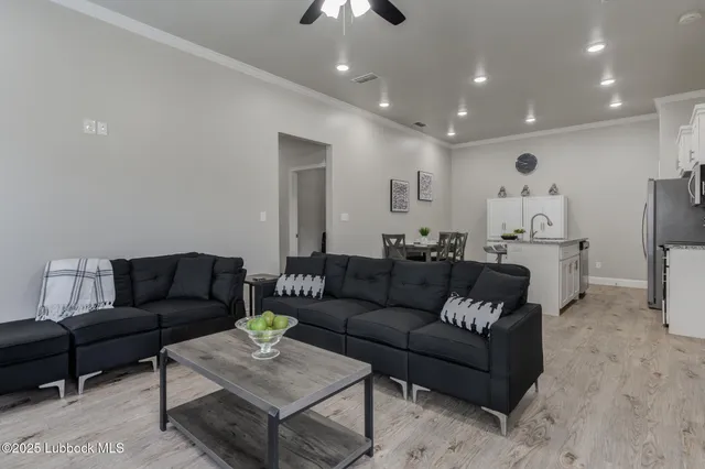 a living room with furniture and a chandelier
