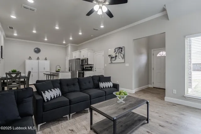 a living room with furniture and a chandelier