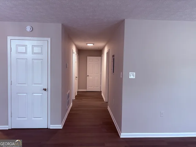 a view of hallway with wooden floor