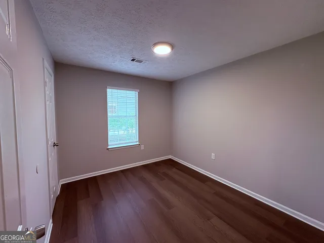 a view of room with window and hardwood floor