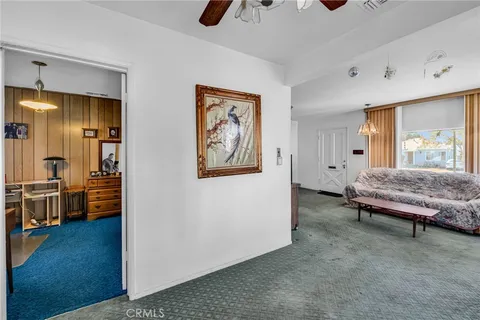 a living room with furniture and a kitchen
