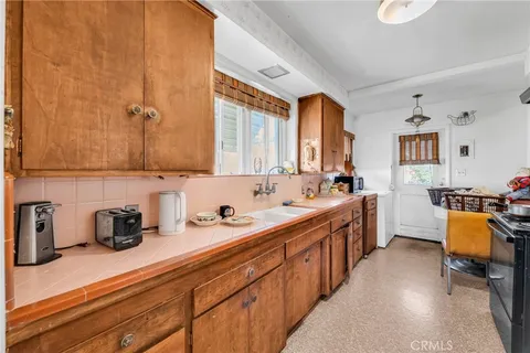 a kitchen with sink cabinets and window