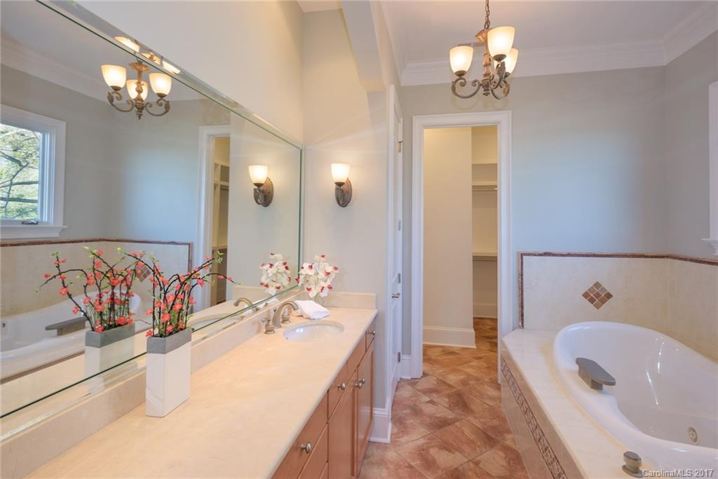 4184 Lake Shore Road South Denver, NC 28037 - Photo 14 of 24 a bathroom with a tub sink and mirror