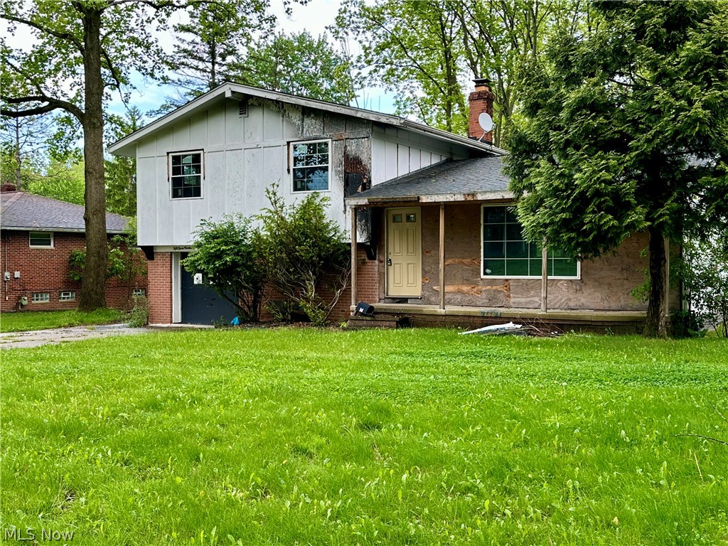 5319 Fairtree Road Bedford Heights, OH 44146 - Photo 1 of 27 Split-level residence featuring a prominent front lawn, mature trees, and a brick-accented lower level