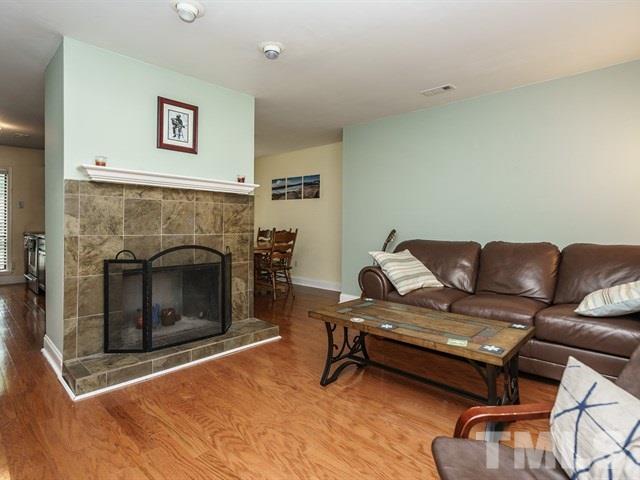 6308 Oakbrook Circle Raleigh, NC 27609 - Photo 5 of 16 The living room has a wood-burning fireplace and new flooring.