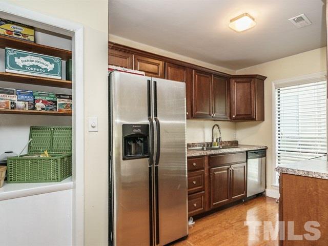 6308 Oakbrook Circle Raleigh, NC 27609 - Photo 7 of 16 Kitchen has newer countertops and cabinets and updated appliances.
