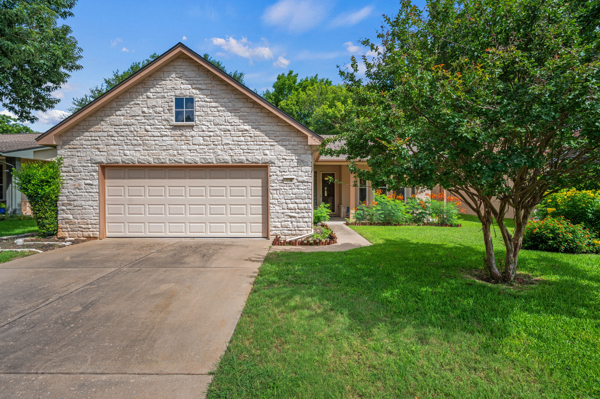 118 Bass Street Georgetown, TX 78633 - Photo 2 of 40 A well-maintained facade with stone accents and a manicured front lawn creates welcoming curb appeal.