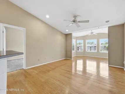 a view of a room with wooden floor