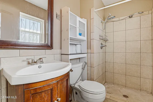 a bathroom with a sink toilet and shower