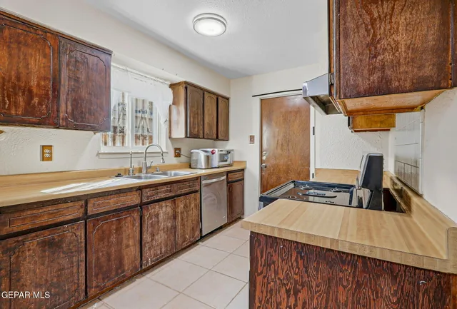a kitchen with a sink stove and cabinets