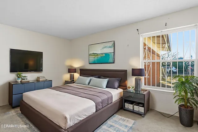 a bedroom with a bed and a flat screen tv