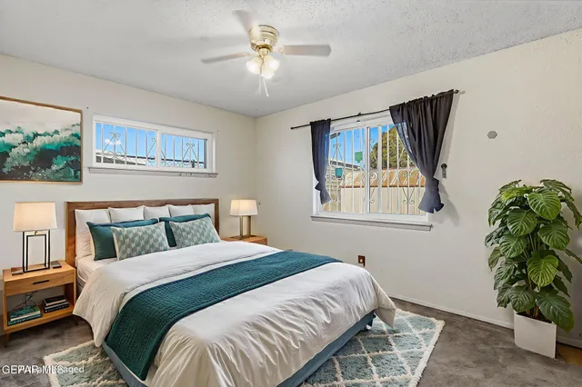 a bedroom with a bed and a painting on the wall