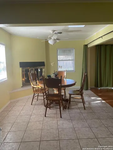 a view of a dining room with furniture and a window