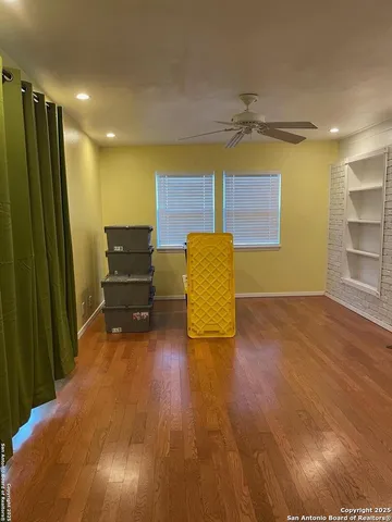 a view of room with window and wooden floor