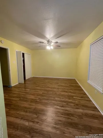 a view of a room with wooden floor