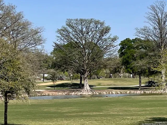 a view of a water fountain and a big yard