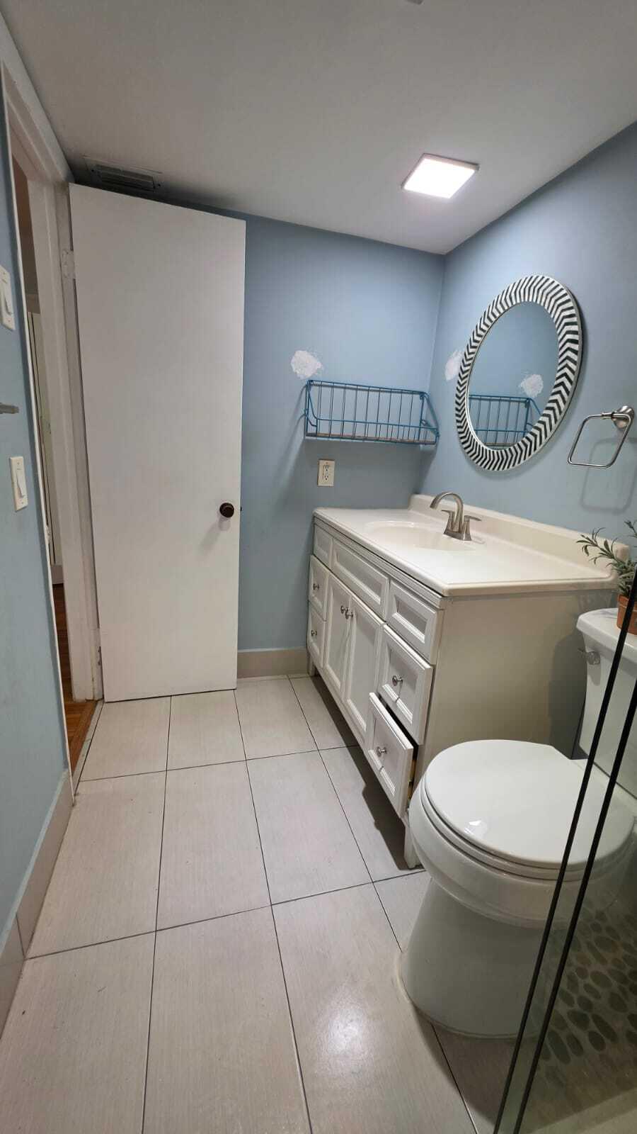 100 Ashbury Road, Unit 206 Hollywood, FL 33024 - Photo 18 of 23 a bathroom with a toilet a sink and a mirror