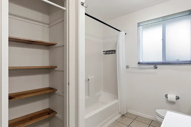 a bathroom with a shower and a toilet