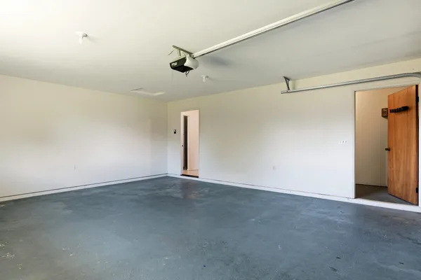 an empty room with a empty space and windows