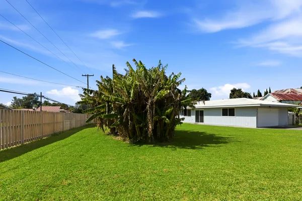a view of a house with a backyard