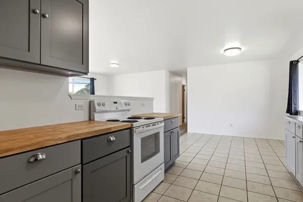 a kitchen with a stove cabinets and a sink