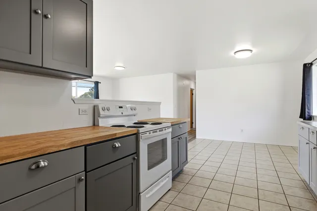a kitchen with a stove cabinets and a sink