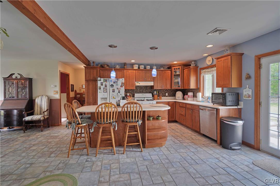 1205 Pine Run Road Lehighton, PA 18235 - Photo 15 of 39 a dining hall with stainless steel appliances a dining table and chairs