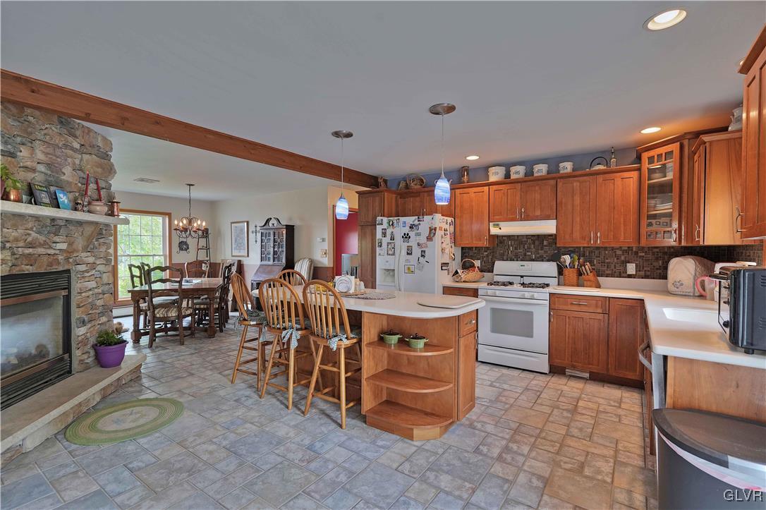 1205 Pine Run Road Lehighton, PA 18235 - Photo 16 of 39 a kitchen with stainless steel appliances a stove a sink dishwasher a oven with a dining table and chairs