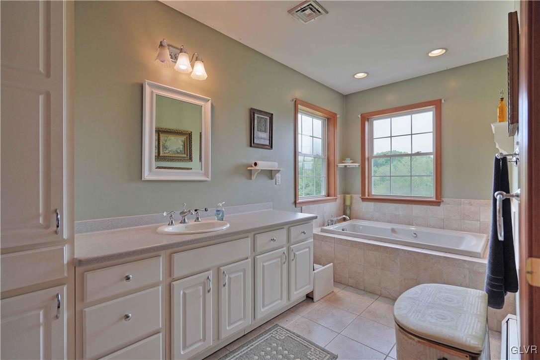1205 Pine Run Road Lehighton, PA 18235 - Photo 19 of 39 a spacious bathroom with a double vanity sink a large mirror and a bathtub