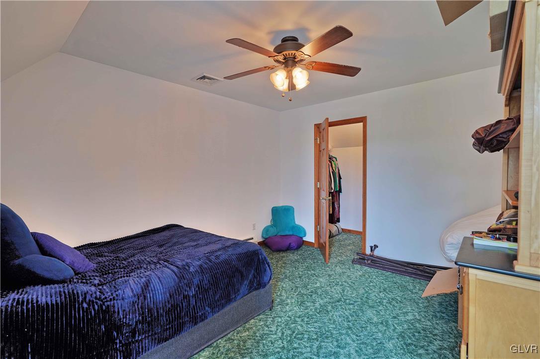 1205 Pine Run Road Lehighton, PA 18235 - Photo 28 of 39 a bedroom with a bed and a chandelier