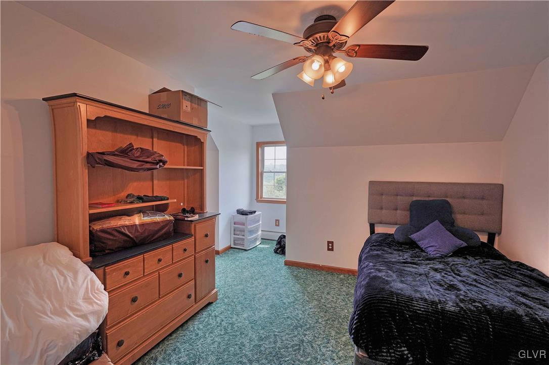 1205 Pine Run Road Lehighton, PA 18235 - Photo 29 of 39 a bedroom with a bed and a chandelier