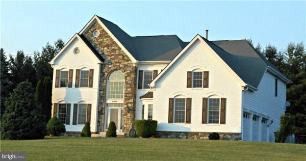 21000 Brooke Knolls Road Laytonsville, MD 20882 - Photo 2 of 20 a view of a white house with a yard and plants