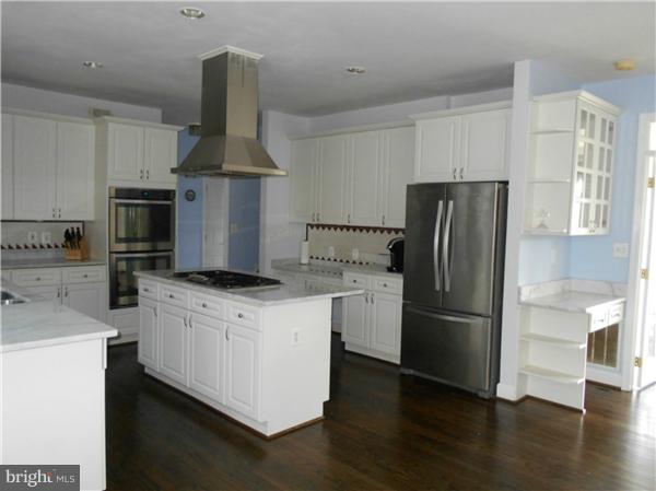 21000 Brooke Knolls Road Laytonsville, MD 20882 - Photo 12 of 20 a kitchen with stainless steel appliances a refrigerator a stove a sink and white cabinets