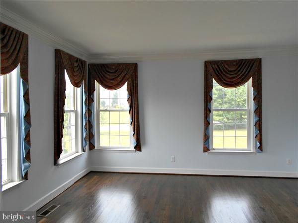 21000 Brooke Knolls Road Laytonsville, MD 20882 - Photo 14 of 20 an empty room with wooden floor and windows