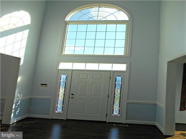 21000 Brooke Knolls Road Laytonsville, MD 20882 - Photo 7 of 20 an empty room with wooden floor and windows