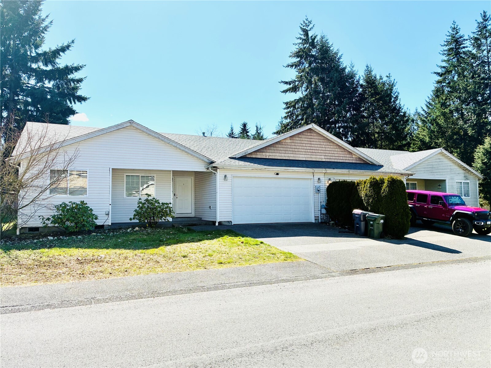 8802 222nd Street East Graham, WA 98338 - Photo 1 of 25 a front view of a house with a yard and garage