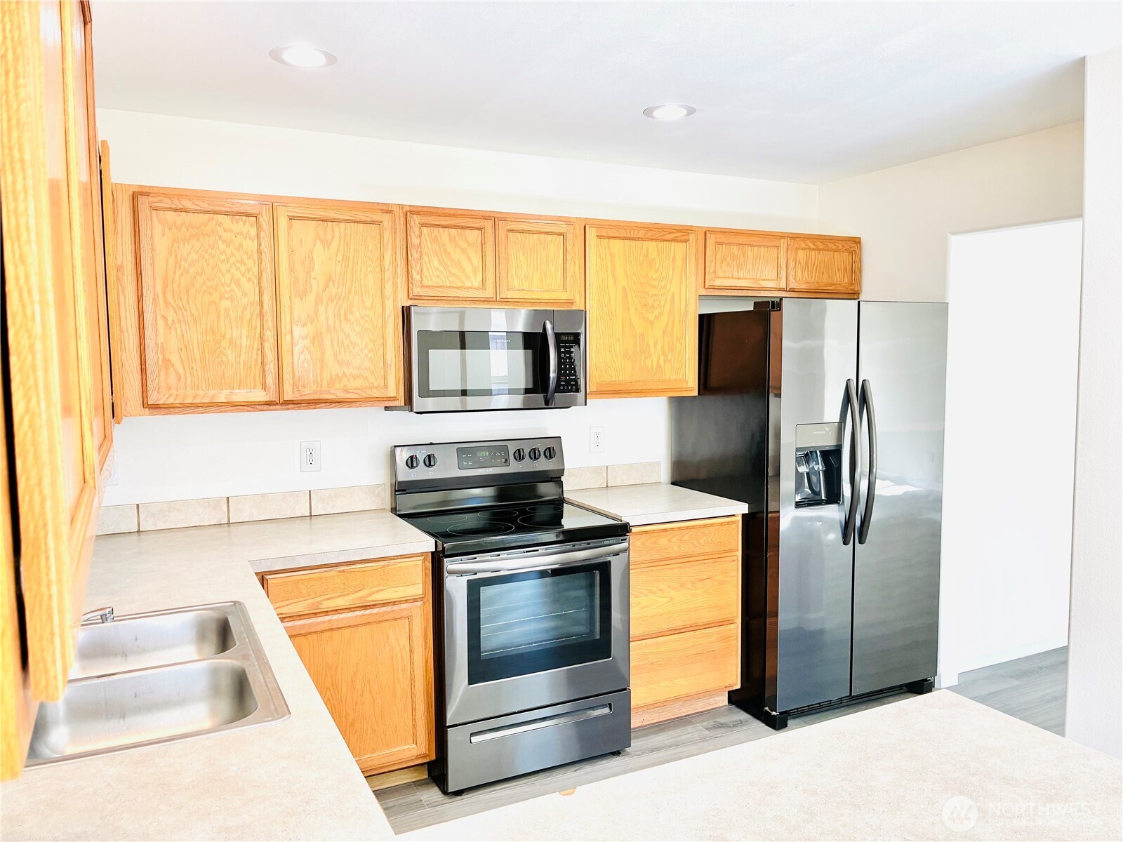 8802 222nd Street East Graham, WA 98338 - Photo 11 of 25 a kitchen with a refrigerator sink and microwave
