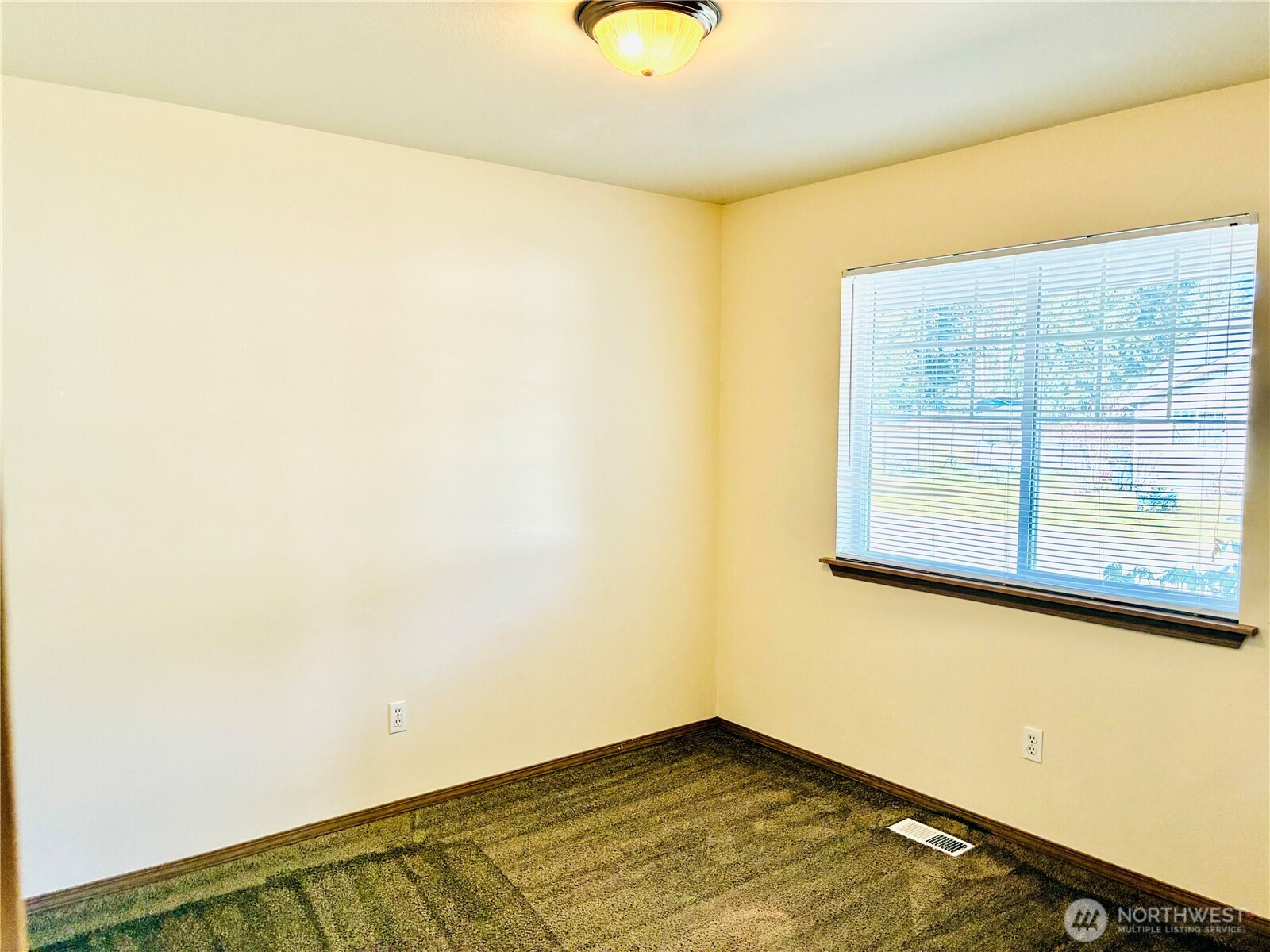 8802 222nd Street East Graham, WA 98338 - Photo 17 of 25 a view of a room with wooden floor and windows