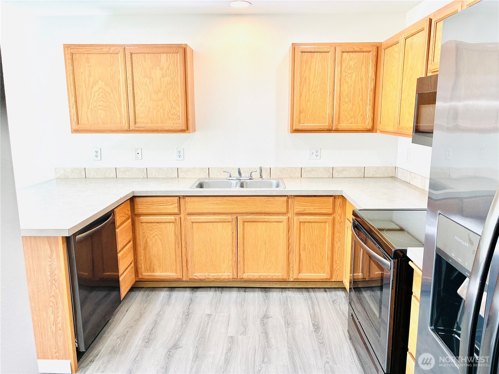 8802 222nd Street East Graham, WA 98338 - Photo 10 of 25 a view of a kitchen with sink and washing machine