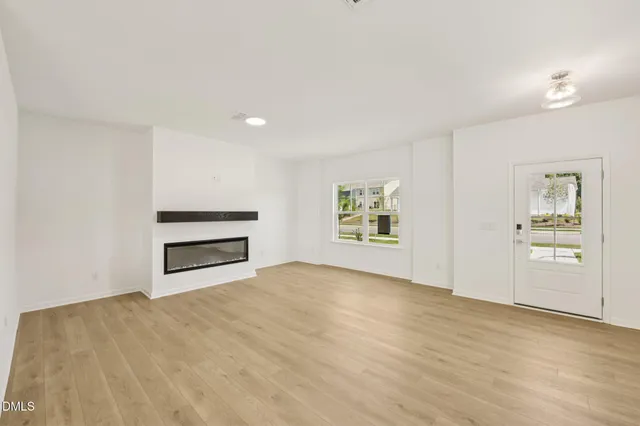 a kitchen with kitchen island granite countertop a sink a stove oven a counter space and cabinets