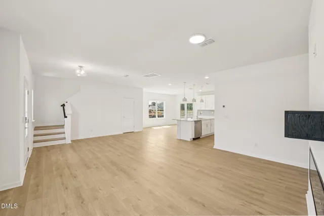 a large white kitchen with stainless steel appliances