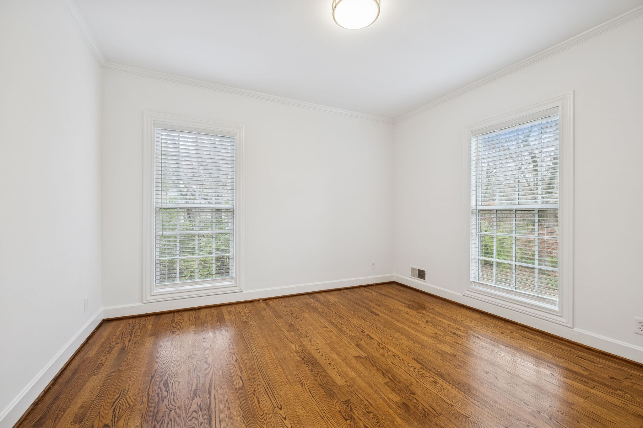6012 Hickory Valley Road Nashville, TN 37209 - Photo 37 of 60 an empty room with wooden floor and windows