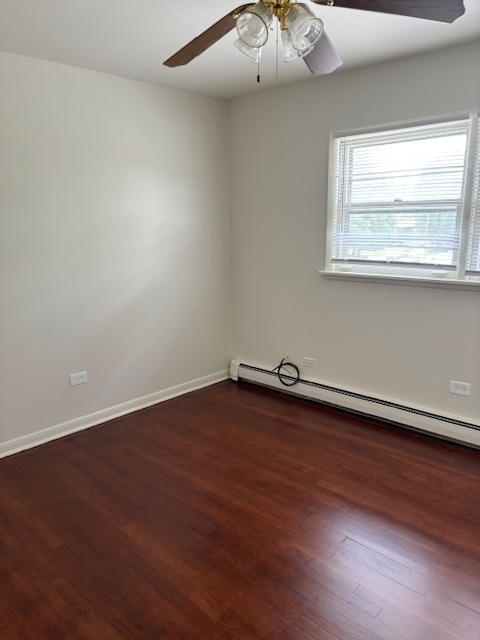372 Yates Avenue, Unit 3 Calumet City, IL 60409 - Photo 6 of 12 an empty room with wooden floor and windows